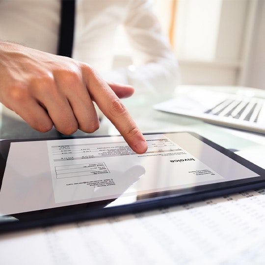 finger touching tablet screen
