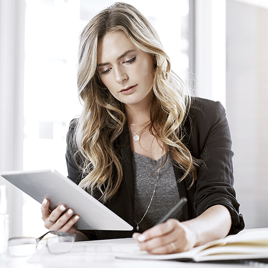 man looking into a tablet