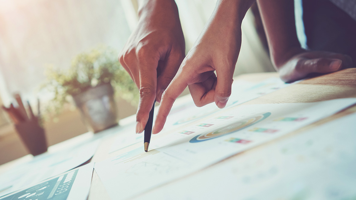 two hands pointing to a work document