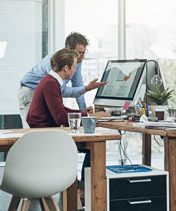 men looking at computer in an office