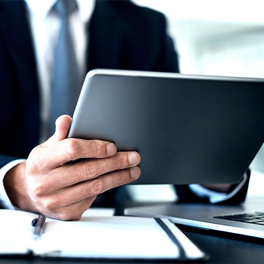 man typing in his tablet