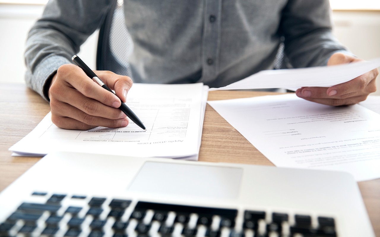 hands writing a report