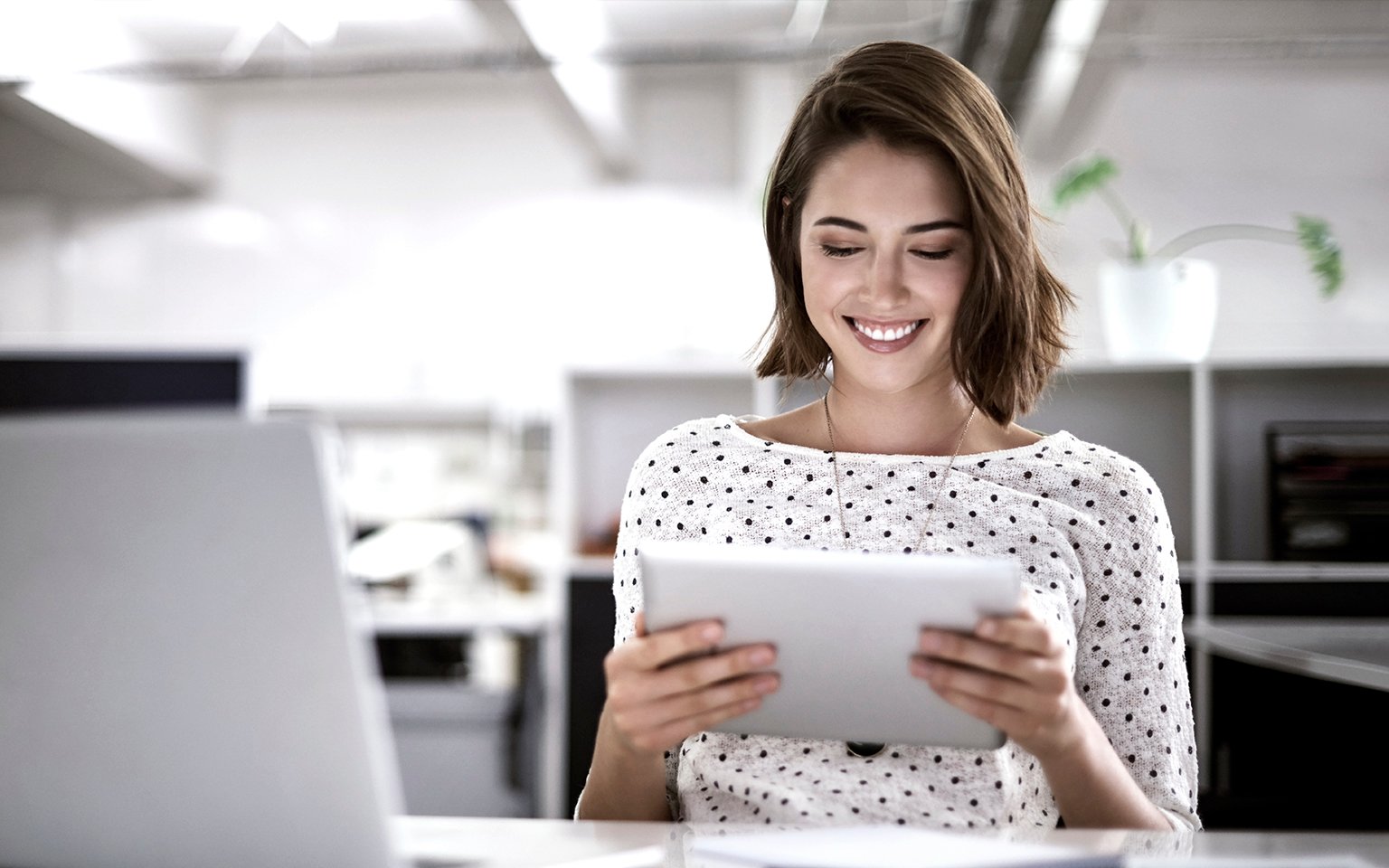 lady smiling looking at a tablet