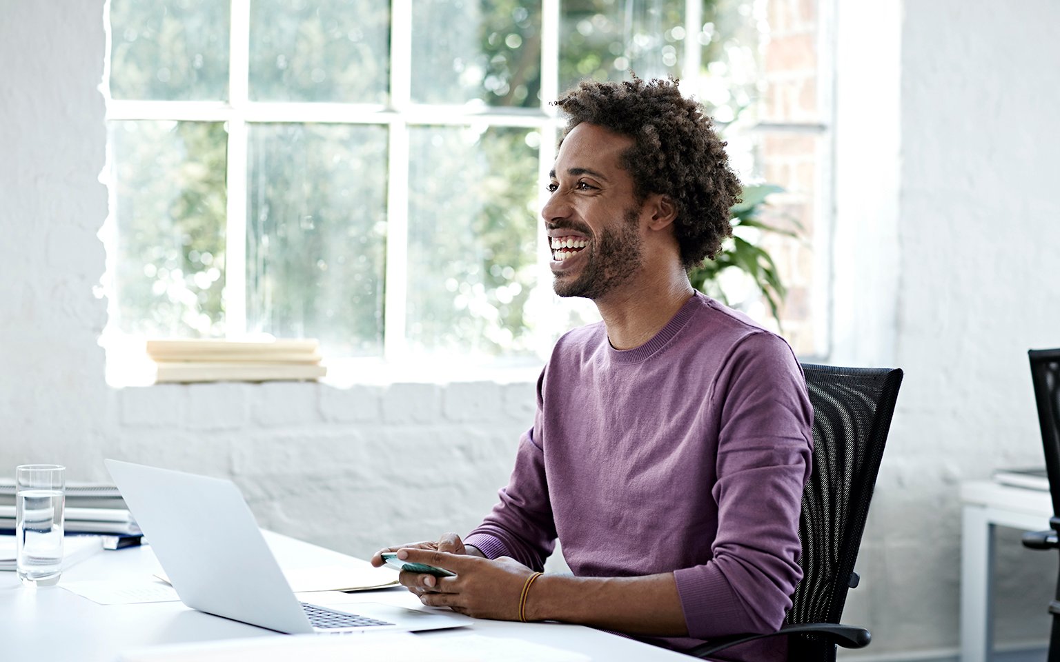 guy smiling in front of a computer