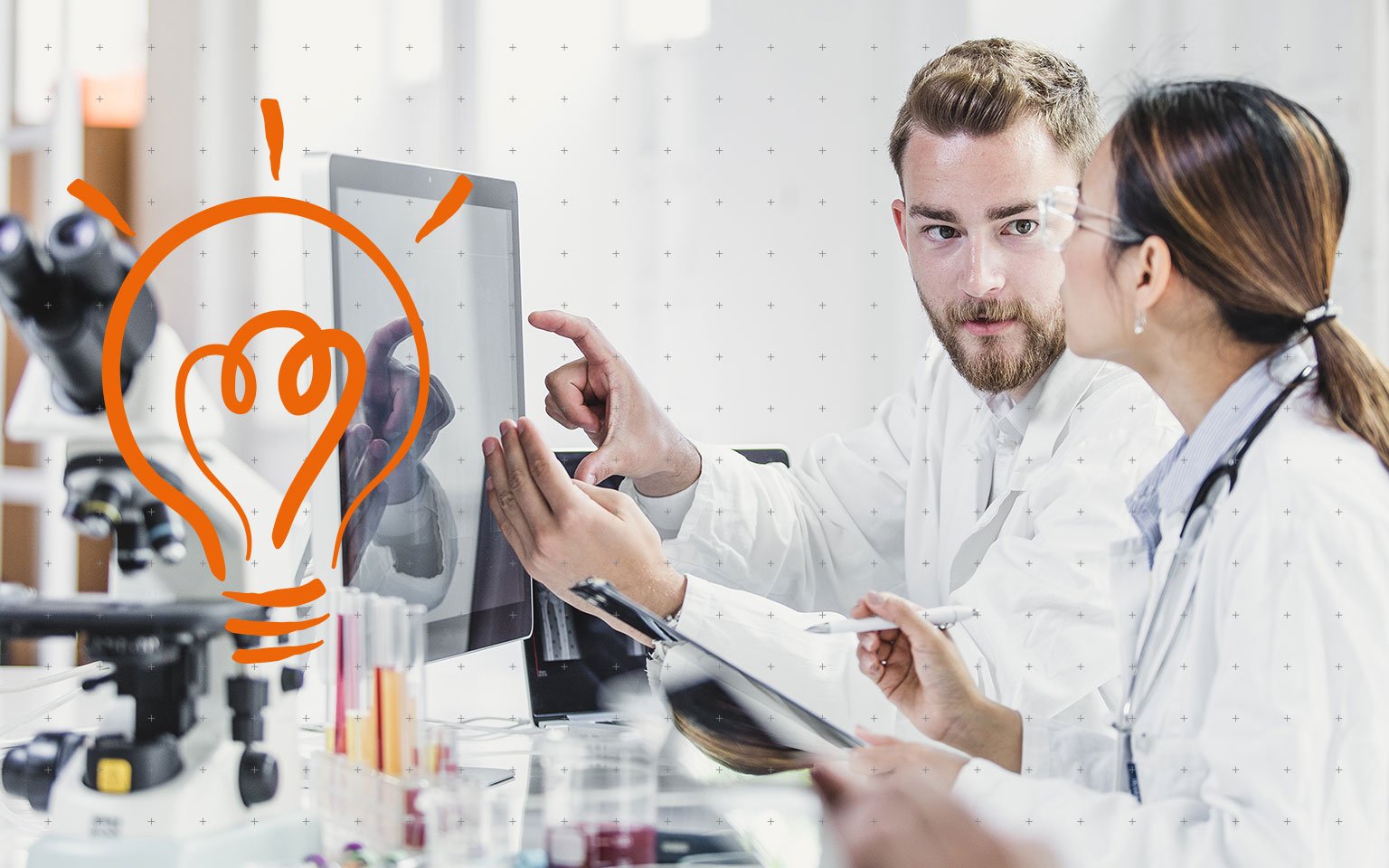 Doctors studying a computer screen and taking notes