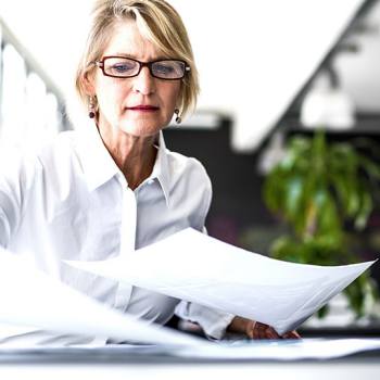 businesswoman sorting papers
